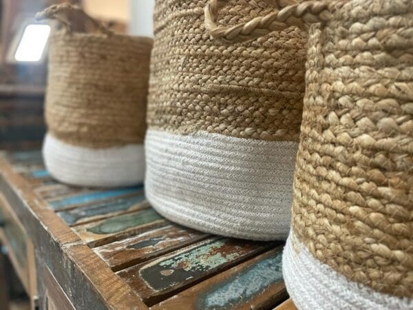 Three baskets are lined up on a table.