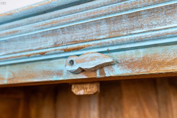 A close up of the handle on a wooden door.