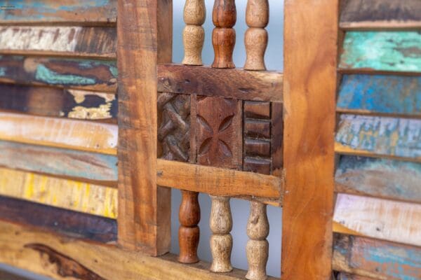 A wooden bench with some wood carvings on it