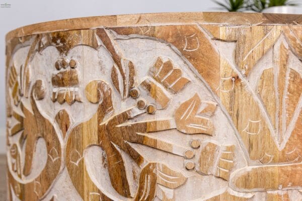 A close up of the wood carving on a wooden bowl