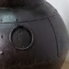 A close up of the top of an iron pot