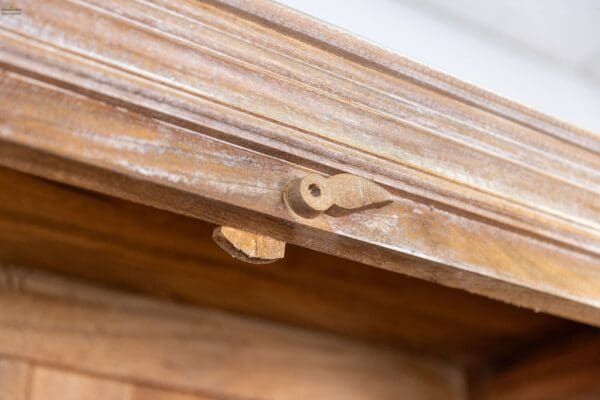 A close up of the key on a wooden door.