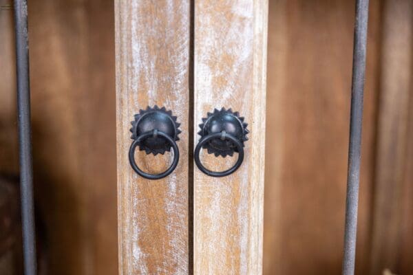 A close up of two wooden doors with metal handles.