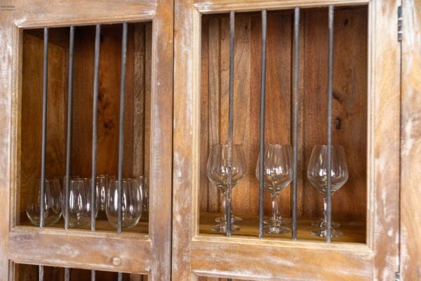 A wooden cabinet with wine glasses in it.