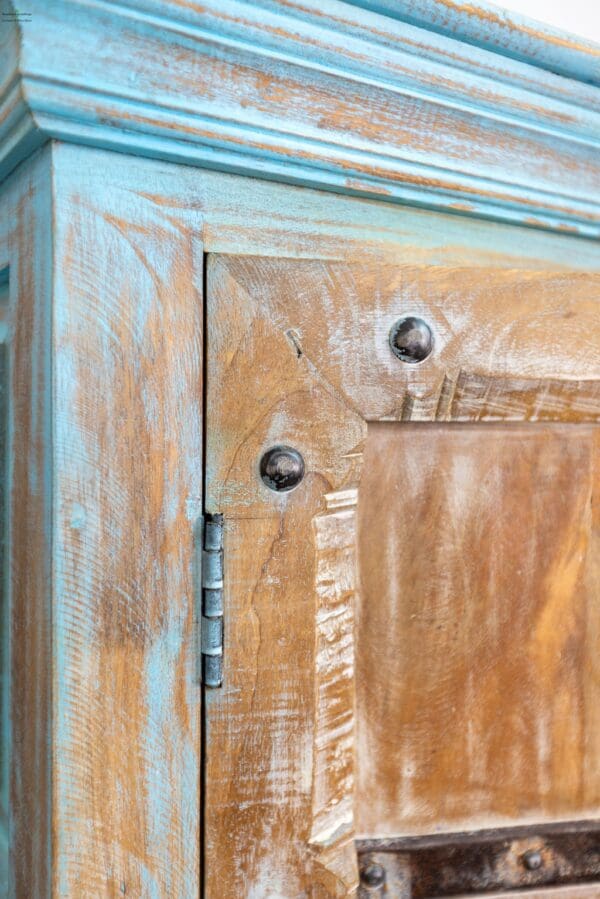 A close up of the door and drawer on an old cabinet.