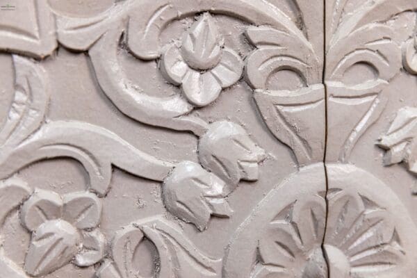 A close up of the carved wood design on a wall