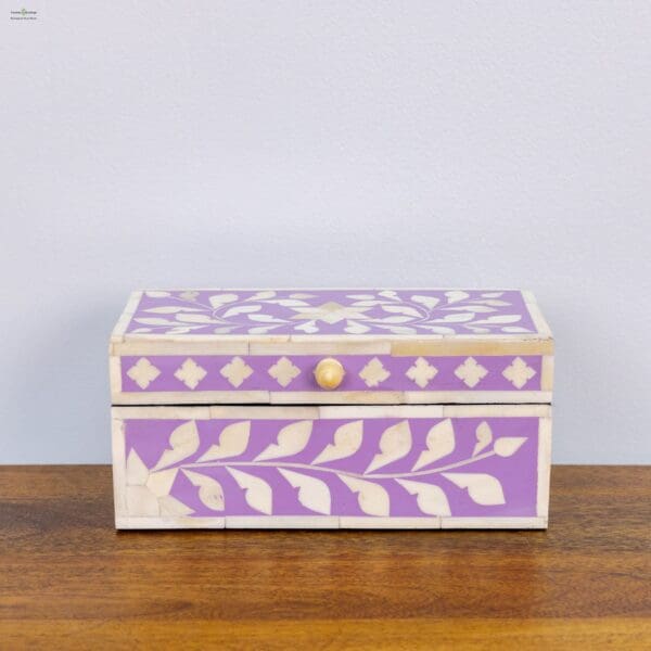 A purple and white box sitting on top of a wooden table.