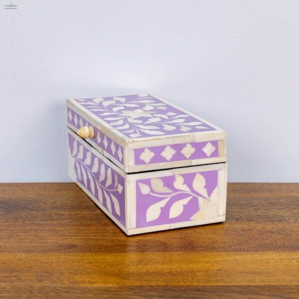 A purple box sitting on top of a wooden table.