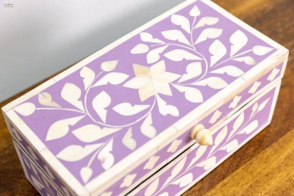 A purple and white jewelry box with two drawers.