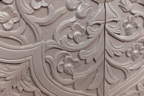 A close up of the carved wood design on the door.