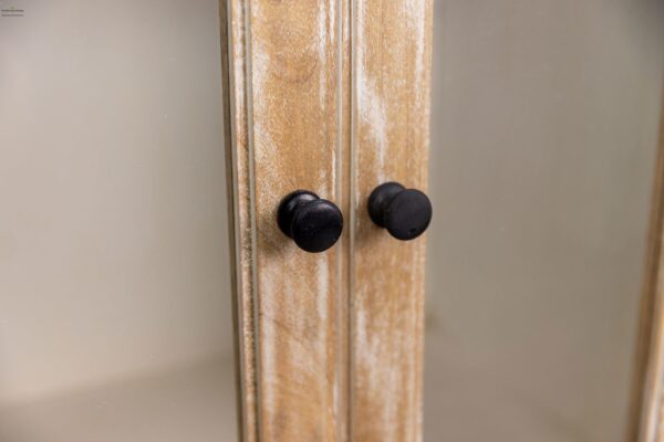 A close up of two knobs on the side of a door.