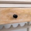 A close up of the drawer handle on a dresser.