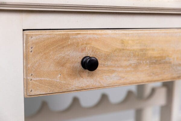 A close up of the drawer handle on a dresser.