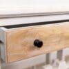 A drawer with a black knob on it.