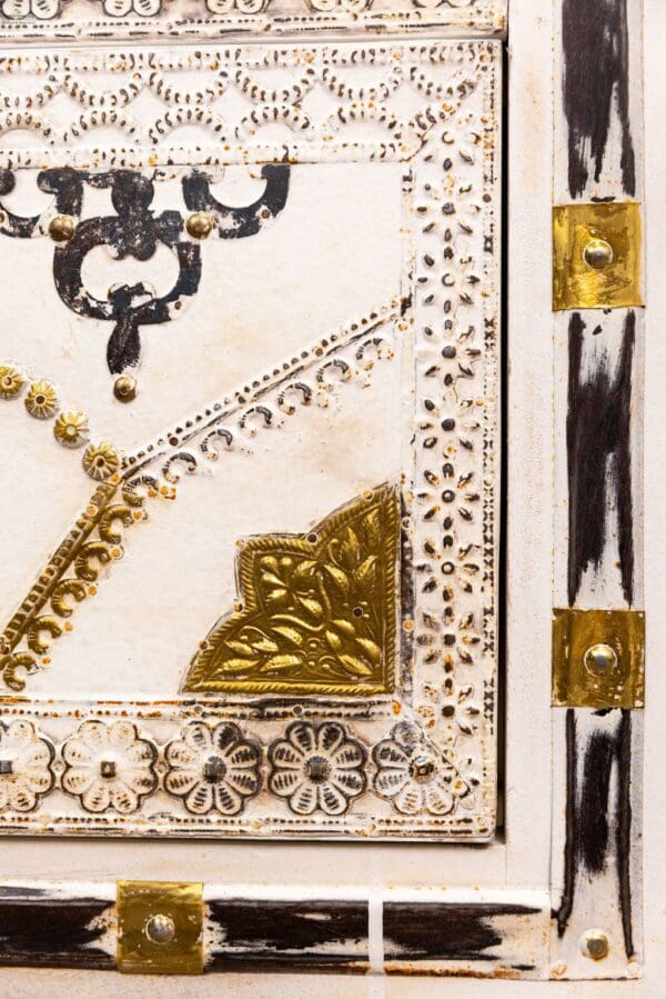 A close up of the corner of a book with gold and black designs.