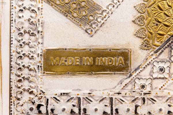 A made in india sign on top of a white background.