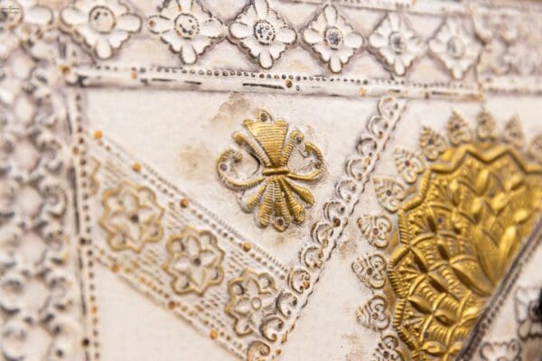 A close up of some gold and white designs