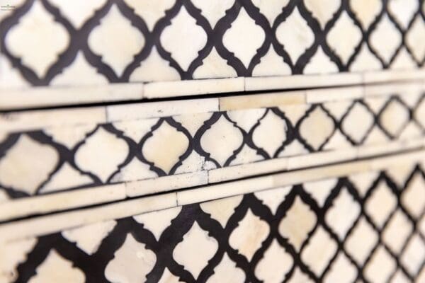 A close up of the black and white tile on the wall.