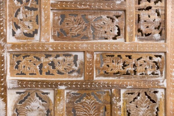 A close up of the carved wood on the wall.