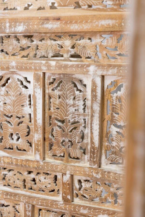 A close up of the carved wood pattern on a wall.