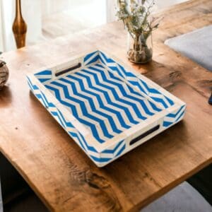 A wooden tray with blue and white pattern on top of a table.