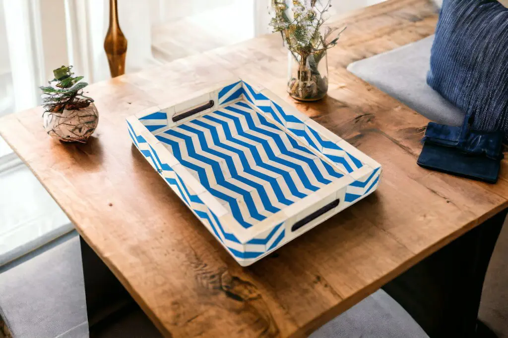 A wooden tray with blue and white pattern on top of a table.