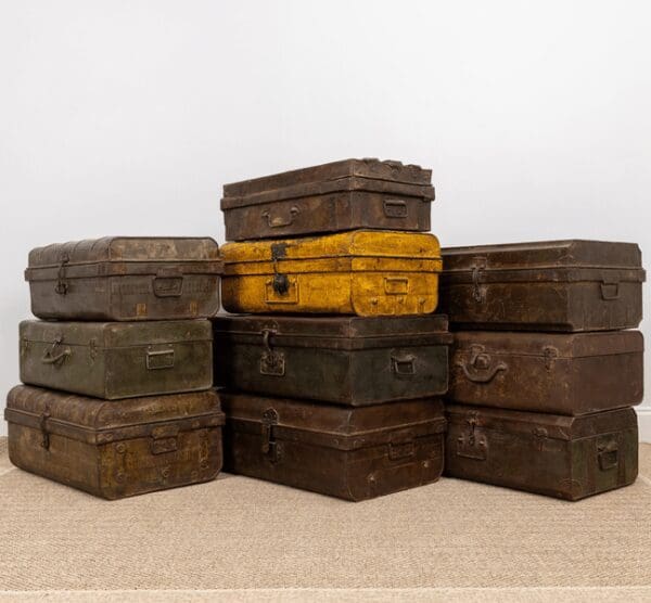 A pile of old suitcases sitting on top of each other.