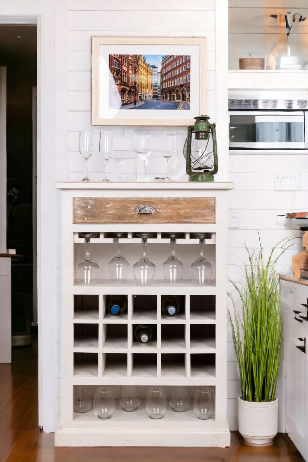 A white wine rack with many glasses on top of it.