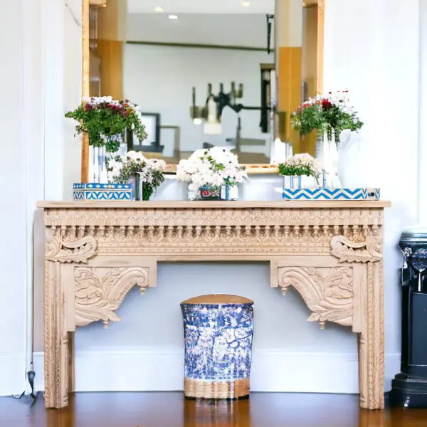 A wooden table with blue and white vases on top of it.