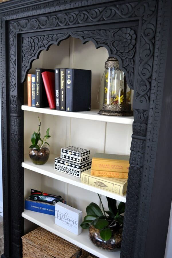 A bookshelf with books and other items on it.