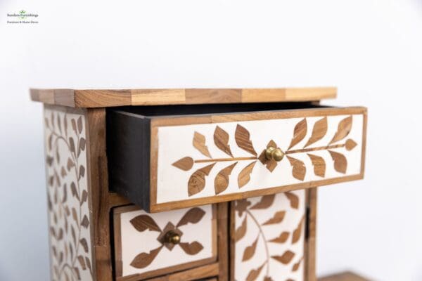 A close up of the drawers on a wooden cabinet