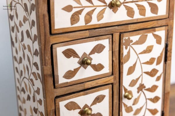 A close up of the drawers and doors on a dresser.