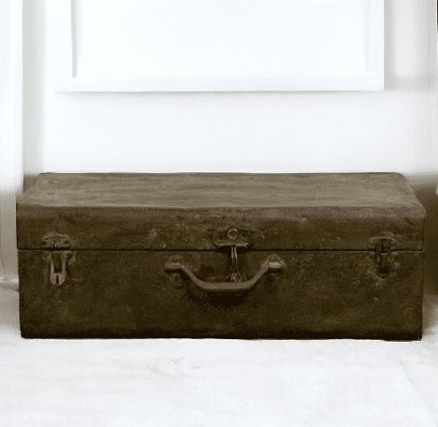 Vintage metal suitcase - option F staged in a home