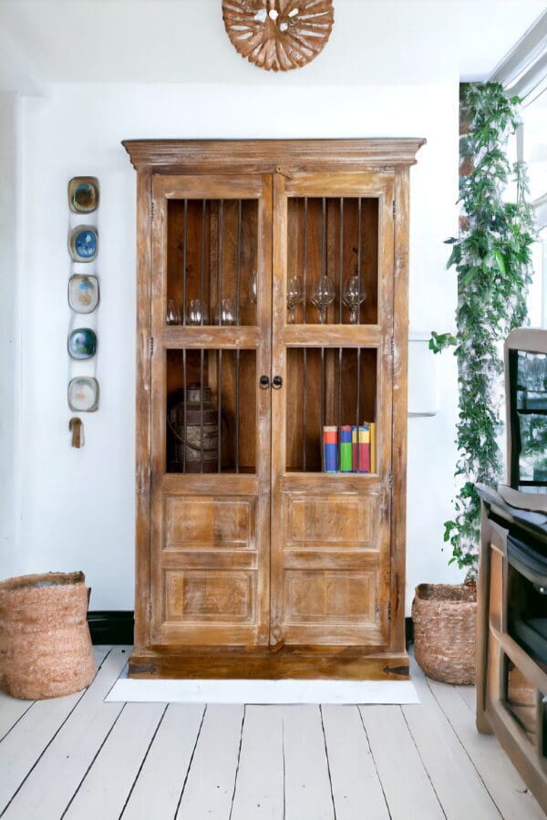 A wooden farmhouse china cabinet with glass doors and shelves.