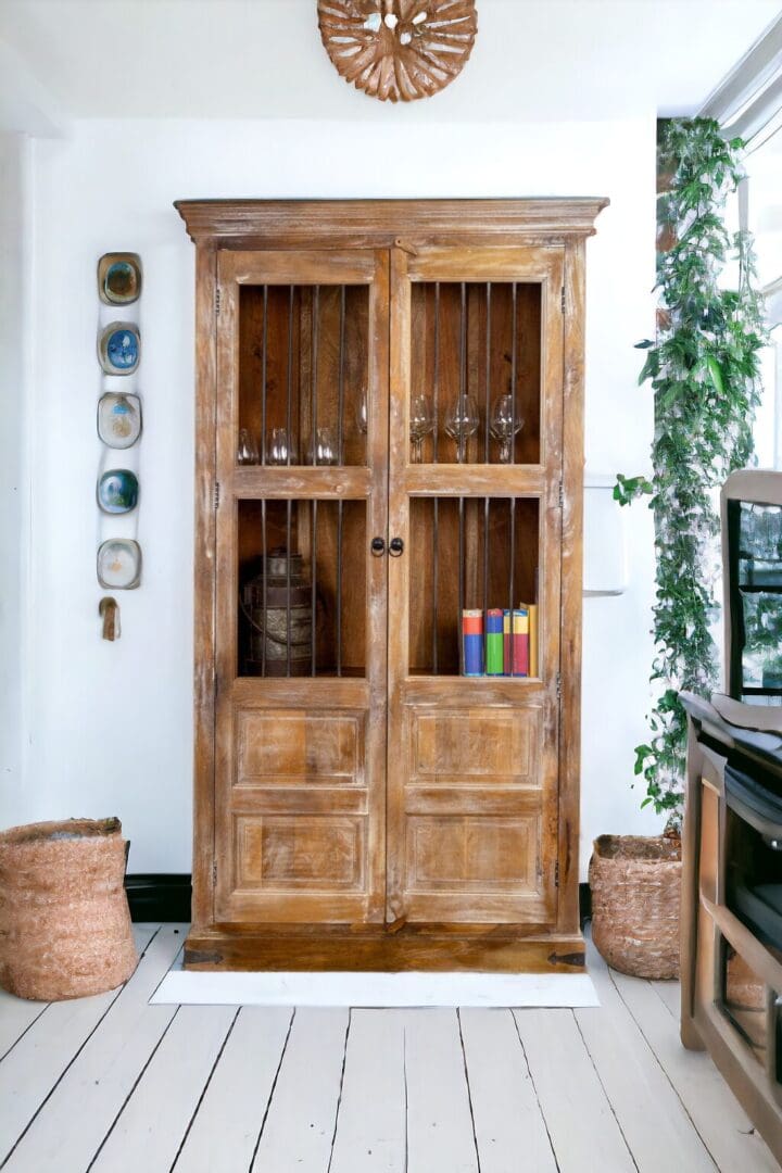 A wooden farmhouse china cabinet with glass doors and shelves.