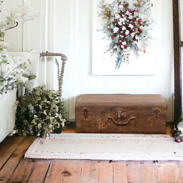 A wooden trunk sitting on top of a hard wood floor.