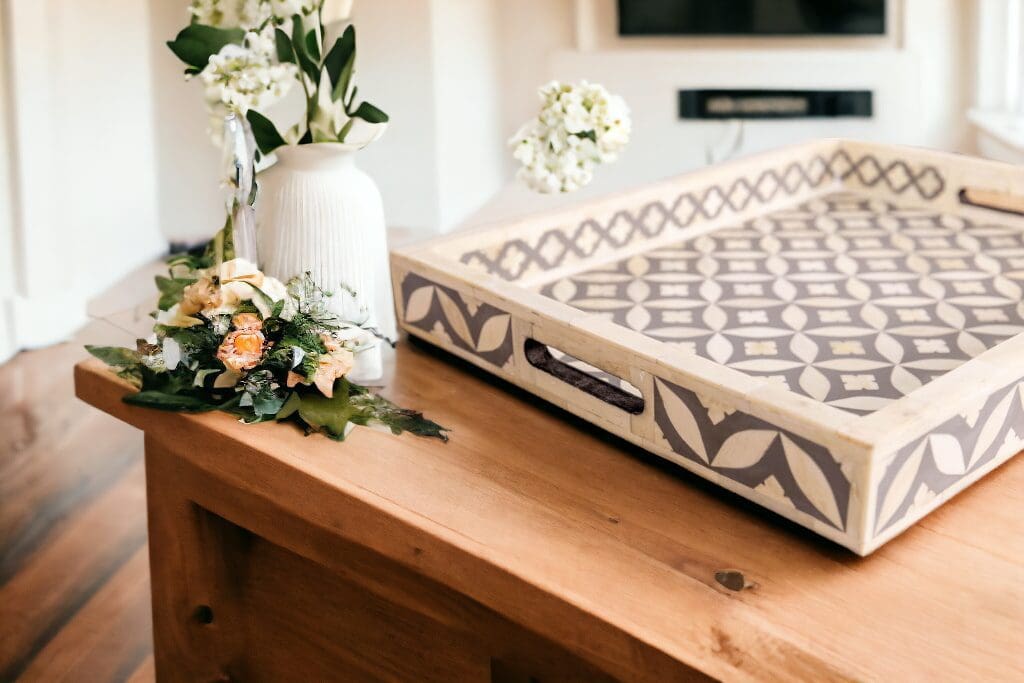 A wooden tray with flowers on top of it.