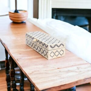 A wooden table with a box on top of it.