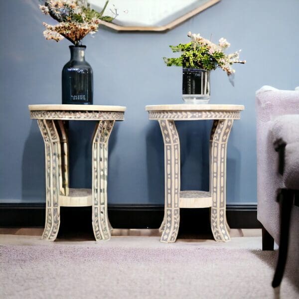 Two tables with vases on top of them in a room.