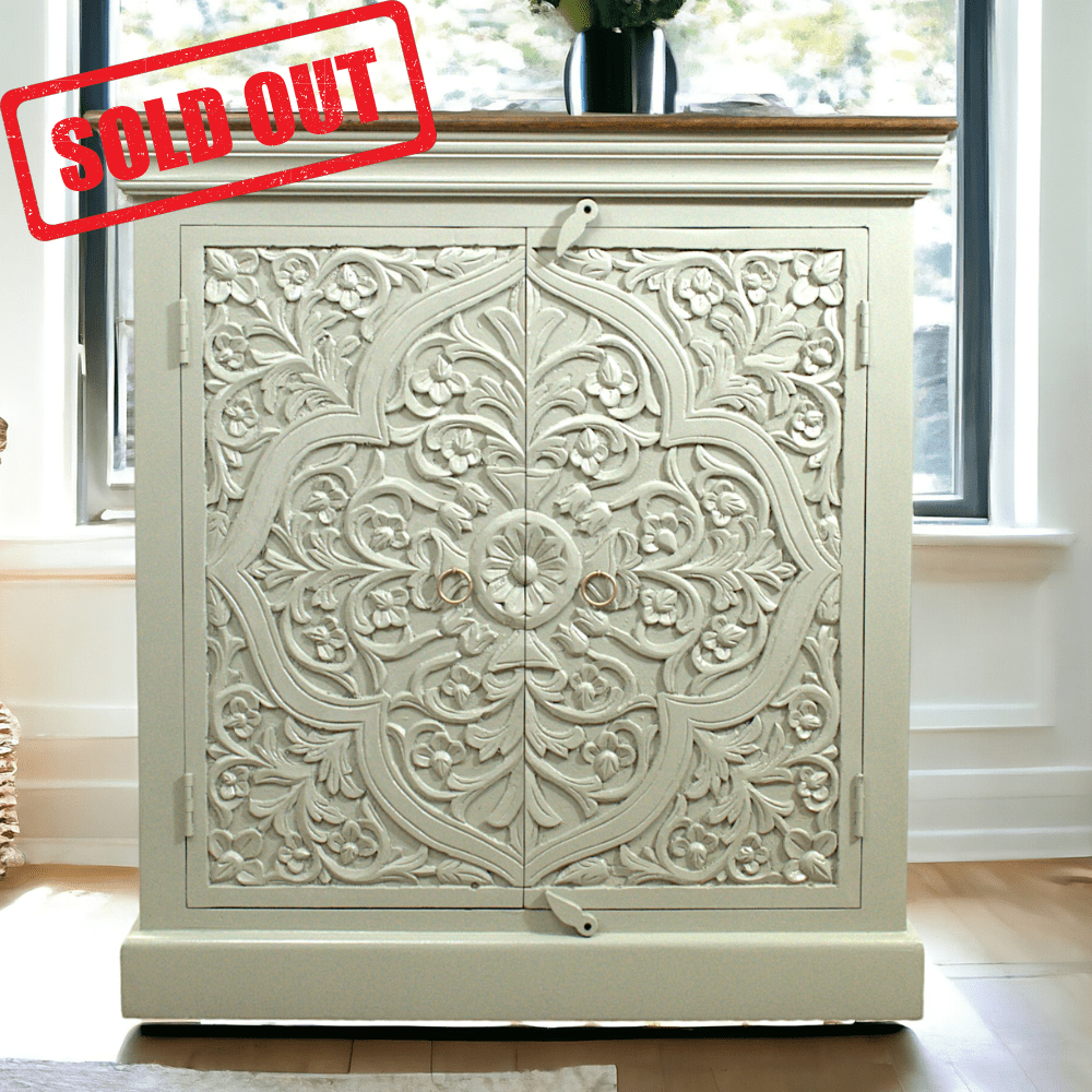 White carved cabinet with floral design.