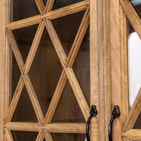 A wooden cabinet with glass doors and black handles.