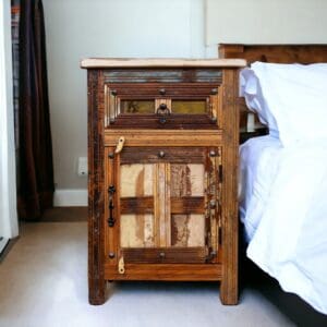 Tall reclaimed wood nightstand staged next to a bed in a bedroom