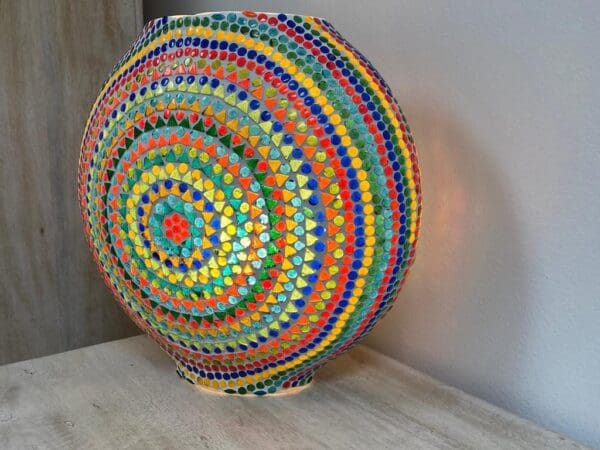 A colorful ball is sitting on the floor.