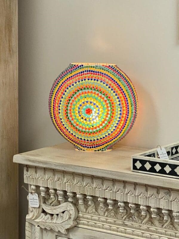 A colorful lamp sitting on top of a table.