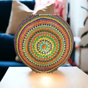 Multicolor round mosaic glass lamp sitting on top of a table.