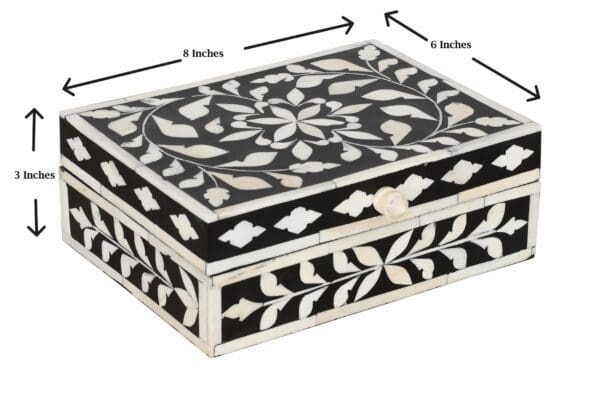 A black and white box with a floral design.