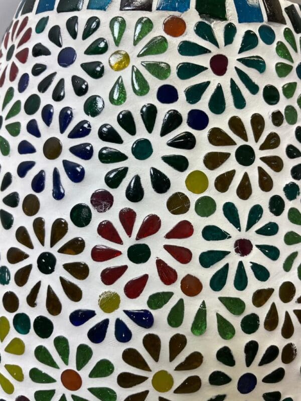 A close up of the colorful glass mosaic on the wall.