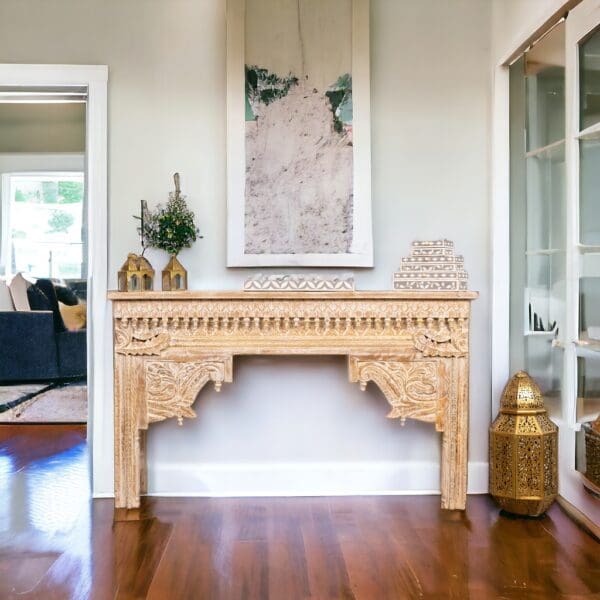 Carved wooden console table with artwork.