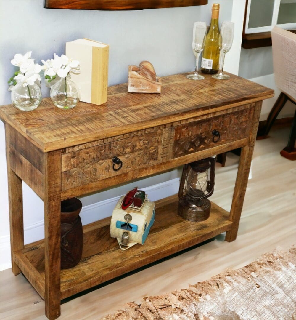 Natural wood console table with 2 drawers and lower shelf, hand-crafted staged in a home with decorative accents.