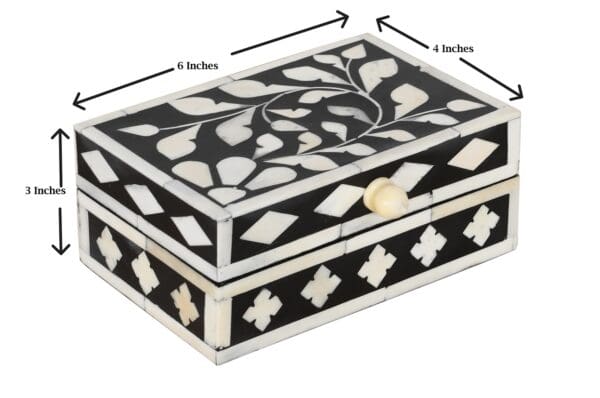 A black and white box with a floral design.